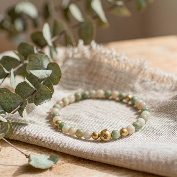 Beaded pet remembrance bracelet in cream, sage and honey tones with an engraved brass charm