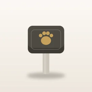 Slate pet memorial garden marker with a short stake and an engraved gold paw outline on a warm ivory surface
