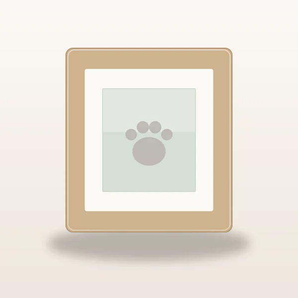 Natural wood pet memorial photo frame holding a soft paw print artwork on a warm ivory surface